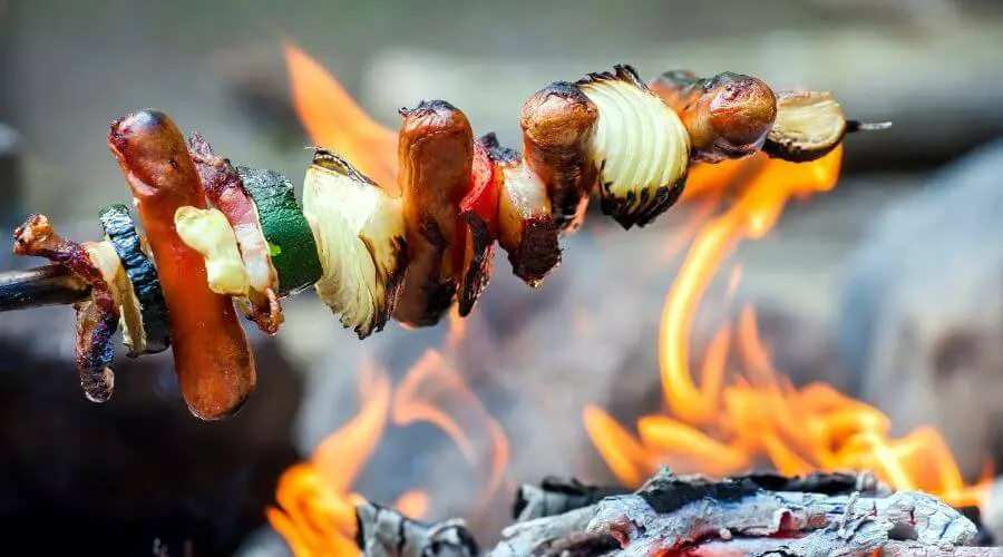 Grilling food on a stick over open flames 