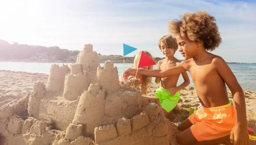 Two boys building a sandcastle on the beach
